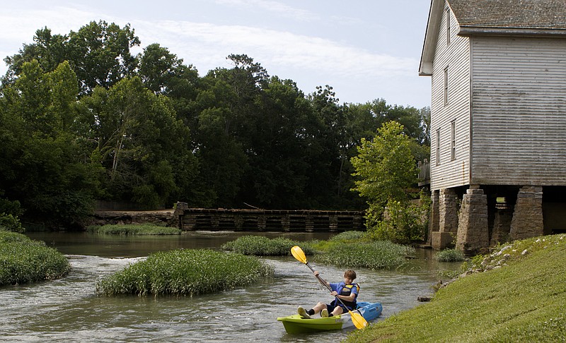 Cody McCutcheon paddles along the West Chickamauga Creek at Lee & Gordon's Mill on Wednesday, June 20, 2018 in Chickamauga, Ga. Walker County announced their "Walker Rocks" marketing initiative at the mill. The initiative is designed to promote the outdoor actives available in Walker County.
