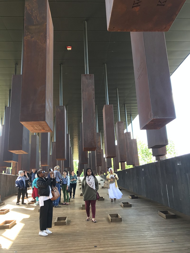 The structure at the center of the National Memorial for Peace and Justice is constructed of more than 800 corten steel monuments, one for each county in the United States where a racial terror lynching took place. The names of the victims are engraved on the columns.