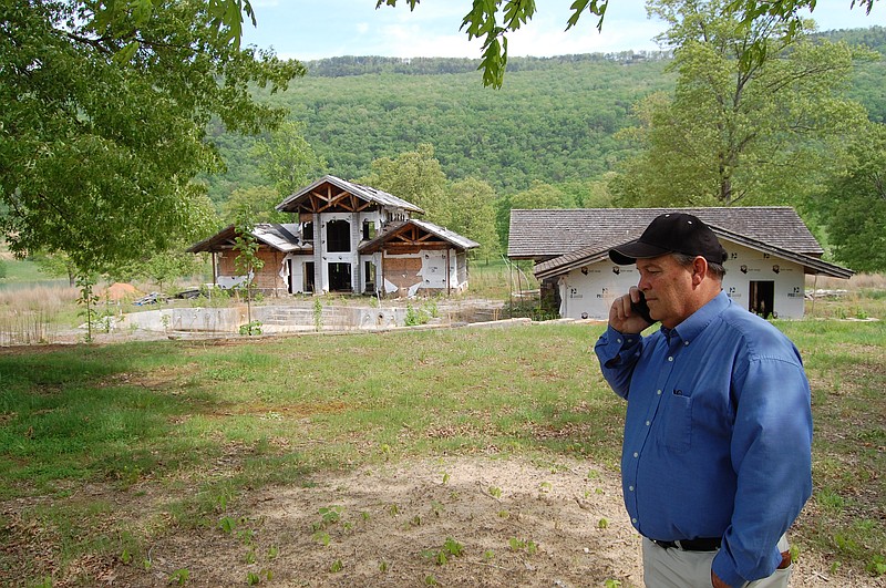 Dade County Executive Ted Rumley looks over the planned community center and swimming pool for The Preserve, a 2,100-acre land development near Rising Fawn, Ga., that went bankrupt. Two men connected to the project were found guilty of fraud and money laundering in federal court last month.