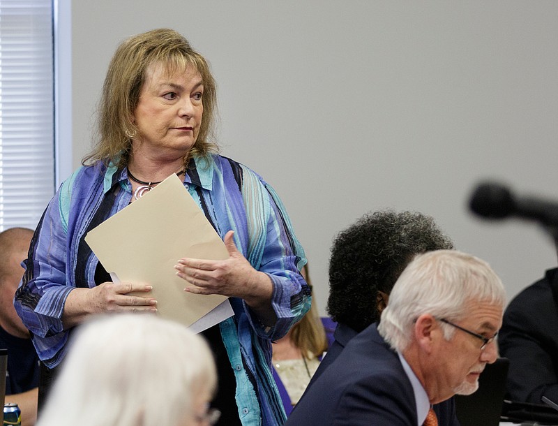 Retired Hamilton County Schools central office worker Jane Barker carries information about a problem that led to her and other retirees being without healthcare after addressing the Hamilton County Board of Education during their meeting on Thursday, June 21, 2018, in Chattanooga, Tenn. 