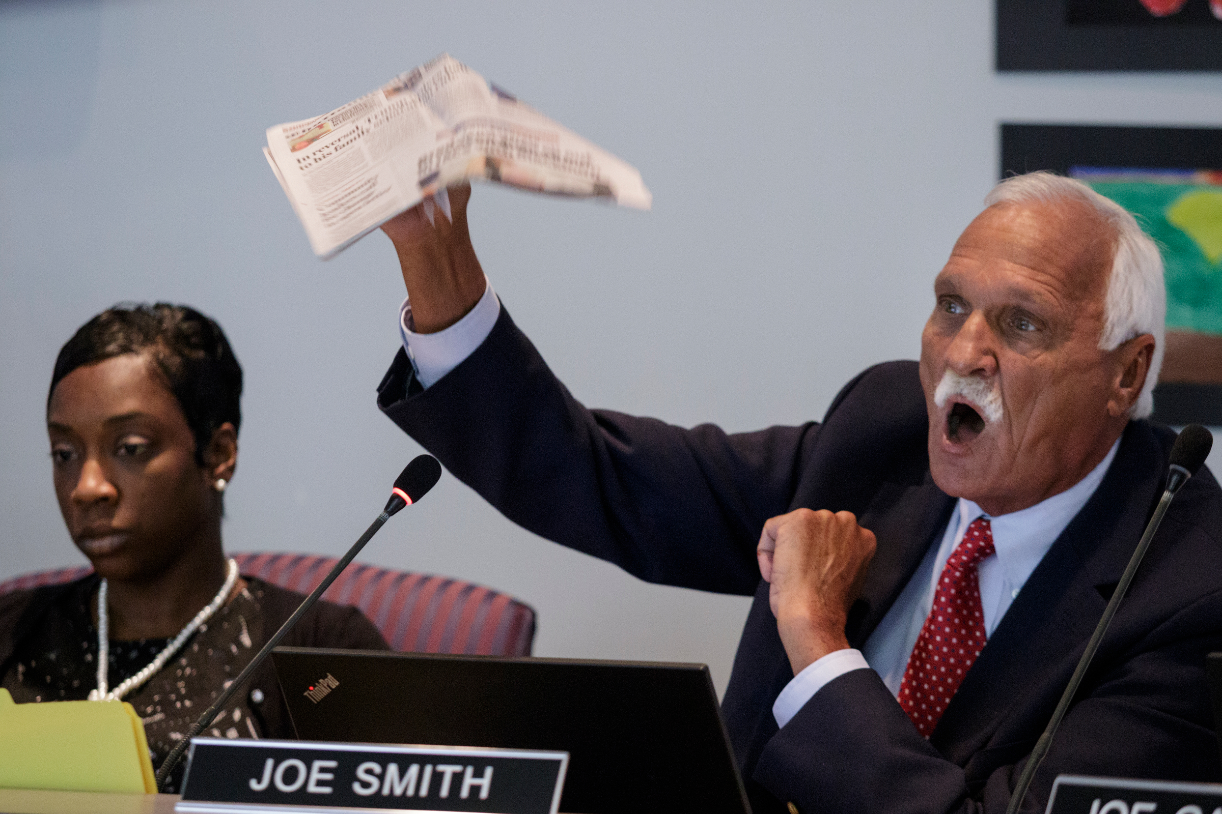 Board member Joe Smith, right, holds up a copy of the Times Free Press as he speaks next to board member Karitsa Mosley Jones amid a discussion about equity in the school system during a Hamilton County Board of Education work session on Thursday, June 21, 2018, in Chattanooga, Tenn.