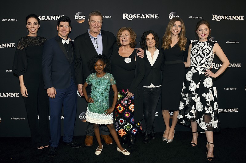 FILE - In this March 23, 2018 file photo, from left, Whitney Cummings, Michael Fishman, John Goodman, Jayden Rey, Roseanne Barr, Sara Gilbert, Sarah Chalke and Emma Kenney arrive at the Los Angeles premiere of "Roseanne" in Burbank, Calif. 