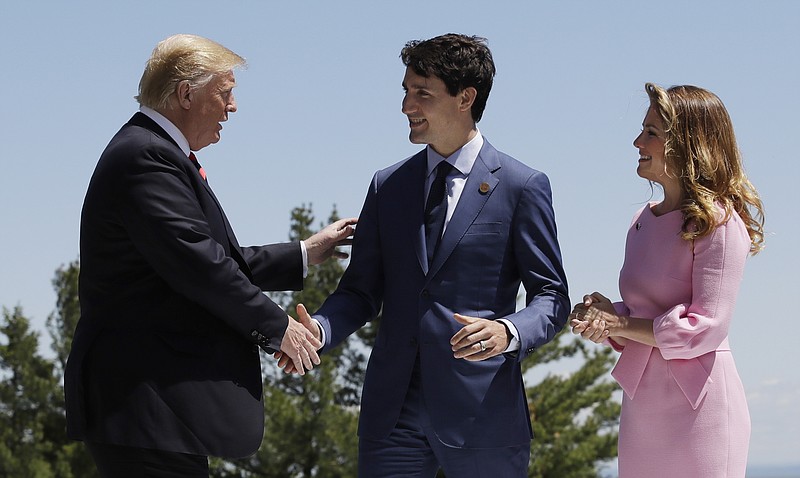 
              In this June 8, 2018 file photo, President Donald Trump is greeted by Canadian Prime Minister Justin Trudeau and his wife Sophie Gregoire Trudeau, during the G7 Summit in Charlevoix, Canada. Americans feel U.S. relations have a better chance at improving in the year ahead with traditionally hostile nations such as North Korea and Russia than they do with allies such as Britain and Canada, according to a new poll from The Associated Press-NORC Center for Public Affairs Research.  (AP Photo/Evan Vucci)
            