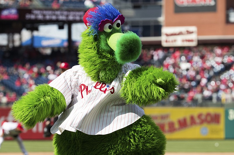 
              In this April 5, 2018 photo, The Phillie Phanatic reacts prior to the first inning of a baseball game against the Miami Marlins  in Philadelphia.   Kathy McVay says she was at Monday, June 18,  Phillies game when the team’s mascot, the Phillie Phanatic, rolled out his hot dog launcher. McVay was sitting near home plate and all of a sudden she says a hot dog wrapped in duct tape struck her in the face.  She left the game to get checked out at a hospital, and she says she has a small hematoma. 
The Phillies apologized to McVay Tuesday and the team has offered her tickets to any game. (AP Photo/Chris Szagola)
            