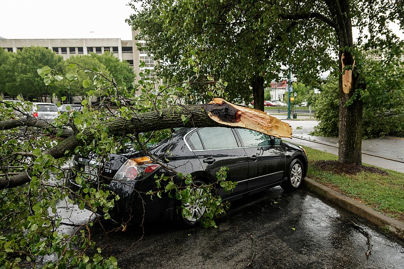 A tree limb fell onto a parked car in a Republic Parking lot near Ross's Landing after afternoon thunderstorms swept through the region on Saturday, June 23, 2018, in Chattanooga, Tenn. 