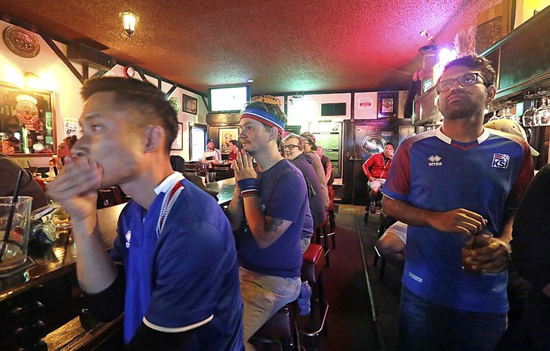 Iceland soccer fans watch the final minutes of the team's loss to Nigeria in a World Cup Group D match Friday on TV at a sports bar in Seattle. Iceland's prime minister has made a direct appeal to soccer fans without a team in the World Cup — including Americans — to pull for her tiny nation.