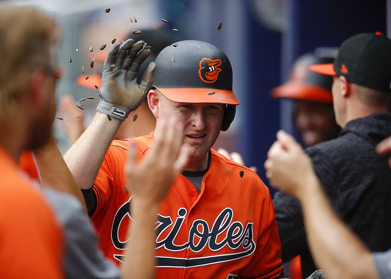 The Baltimore Orioles' Mark Trumbo celebrates after hitting a grand slam in the first inning of Saturday's game in Atlanta. Baltimore won 7-5 for its second straight victory against the Braves.