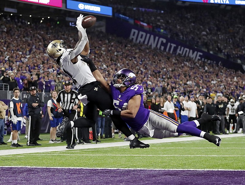 New Orleans Saints running back Alvin Kamara makes a touchdown catch over Minnesota Vikings middle linebacker Eric Hendricks during the second half of a playoff game this past January in Minneapolis. Kamara, who finished his collegiate career at Tennessee, was in Chattanooga on Saturday to conduct a camp and lead some youth football players on a shopping spree.