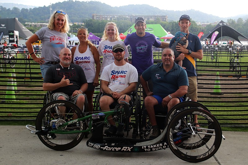 Team members with SPARC racing pose for a photo Saturday, June 23 near Ross's Landing. The team features handicapped racers who will be competing in today's Chattanooga Waterfront Triathlon.