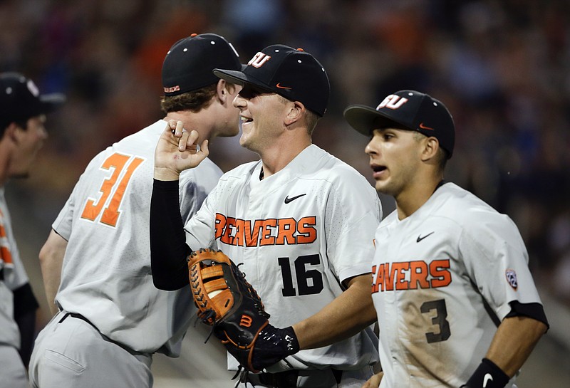 Oregon State first baseman Zak Taylor (16) celebrates after a double play against Mississippi State ended the sixth inning of their College World Series elimination game Saturday night. Oregon State won 5-2 to advance to the best-of-three finals against Arkansas. The championship series starts tonight.