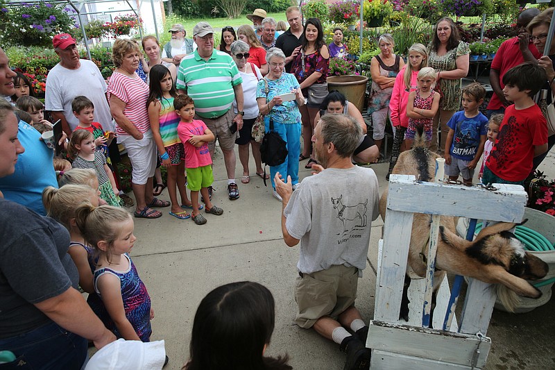 Guests circle around as Bill Ensinger of Dixie Soaps hosts a goat milking demonstration at Ooltewah Nursery & Landscape Co. It was the third annual goat milking demonstration held at the nursery.