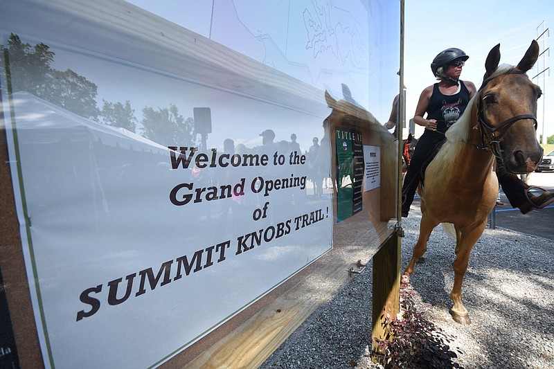 Christi Lewis waits atop her horse Whiskey at the Grand Opening of the Summit Knobs Trail Monday at Enterprise South. Several dozen horses and owners from all over east Tennessee were mounted and rode the trail following a ribbon cutting by Bobby Mitchell, president of the South Appalachian Back Country Horsemen.