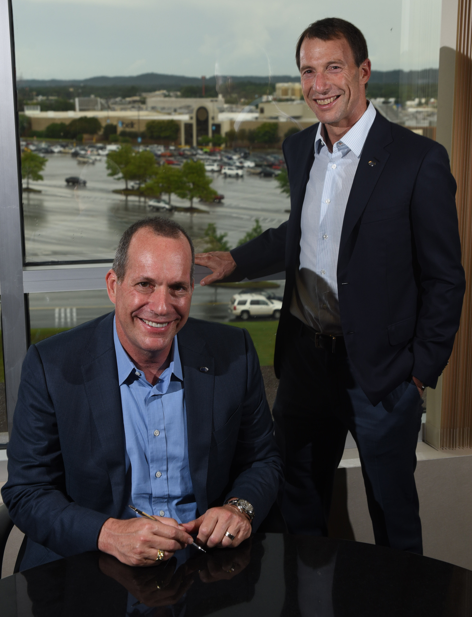 Staff photo by Tim Barber CBL Properties' CEO Stephen Lebovitz, right, stands with recently named company president Michael Lebovitz Monday in the corporate headquarters adjacent to Hamilton Place mall.