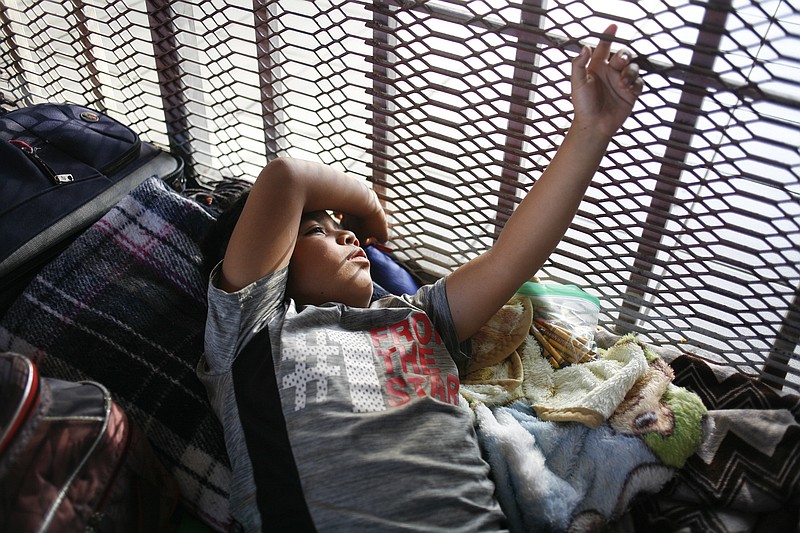 For families waiting to request asylum in the United States, a small patch of ground is now their bedroom, washroom, school, kitchen and playground. This boy left his home in Nogales, Mexico. (Julie Turkewitz/The New York Times)