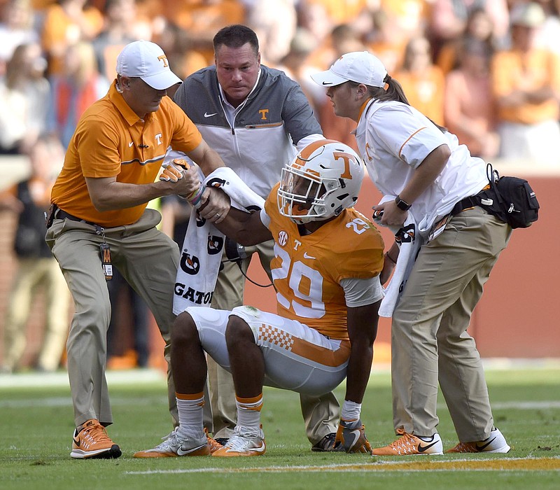 Tennessee's Evan Berry (29) is helped up by trainers and head coach Butch Jones. Berry left the game with a injury.   The Tennessee Tech Golden Eagles visited the Tennessee Volunteers in NCAA football action at Neyland Stadium in Knoxville on November 5, 2016.