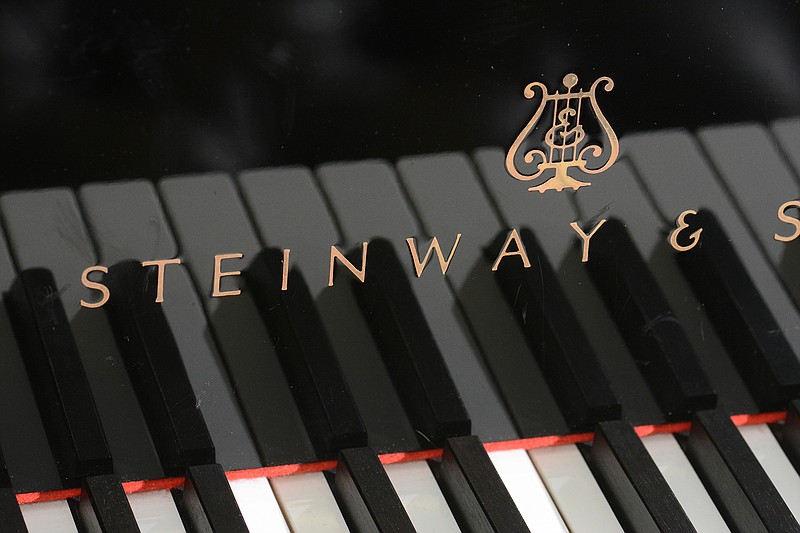 In this 2015 staff file photo, the Steinway and Sons logo is seen on a grand piano at Summitt Pianos in Chattanooga, Tenn.