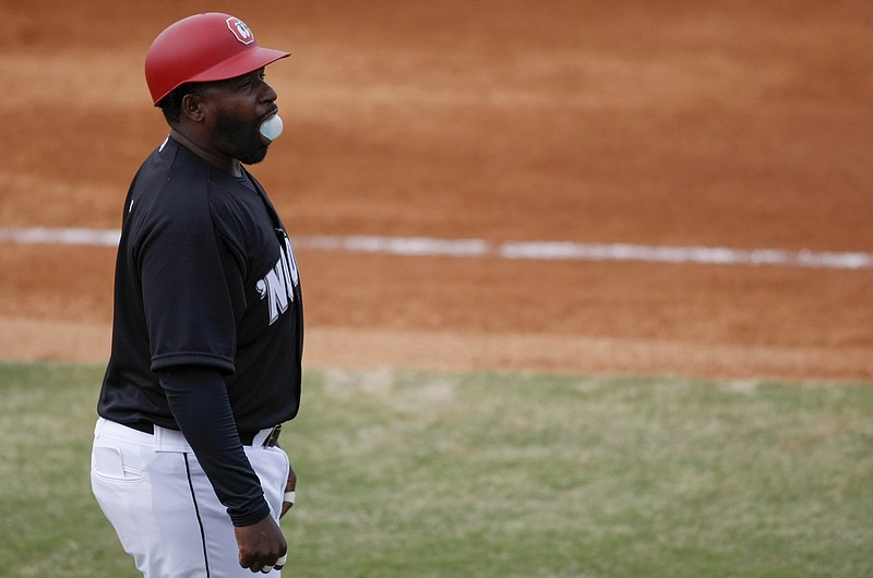 Lookouts manager Tommy Watkins (8) blows a bubble on opening day against the Birmingham Barons at AT&T Field on Thursday, April 5, 2018 in Chattanooga, Tenn.