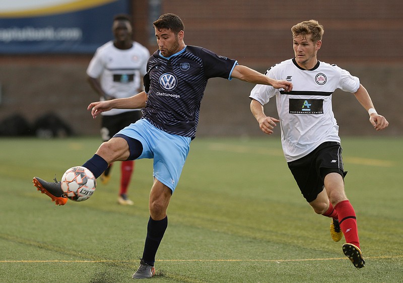 CFC's Pablo Gaona takes a shot on the goal around Atlanta's Aaron Walker during Chattanooga FC's soccer match against the Atlanta Silverbacks at Finley Stadium on Wednesday, June 20, 2018, in Chattanooga, Tenn. 