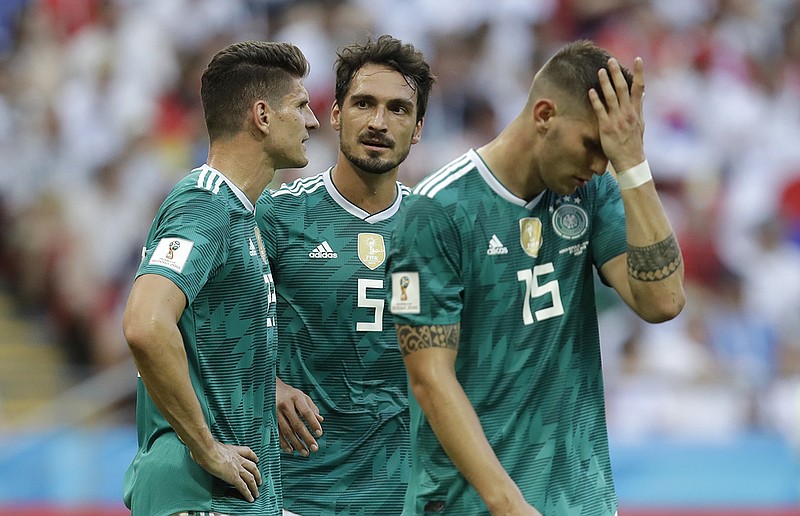 From left, Germany's Mario Gomez, Mats Hummels and Niklas Suele react after losing 2-0 to South Korea in their World Cup Group F finale Wednesday in Kazan, Russia. Germany, the tournament's 2014 champion, was eliminated with the loss.