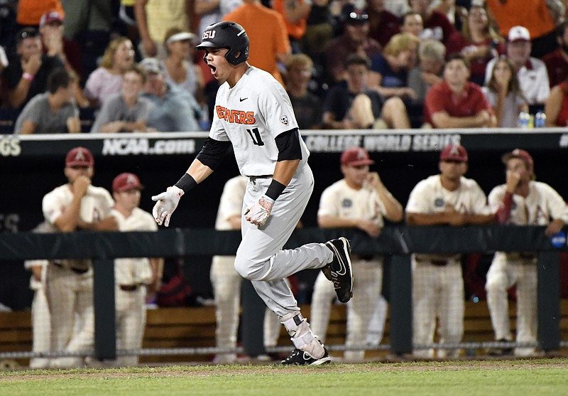 
              Oregon State's Trevor Larnach (11) celebrates his two-run home run against Arkansas during the ninth inning in Game 2 of the NCAA College World Series baseball finals in Omaha, Neb., Wednesday, June 27, 2018. (AP Photo/Ted Kirk)
            