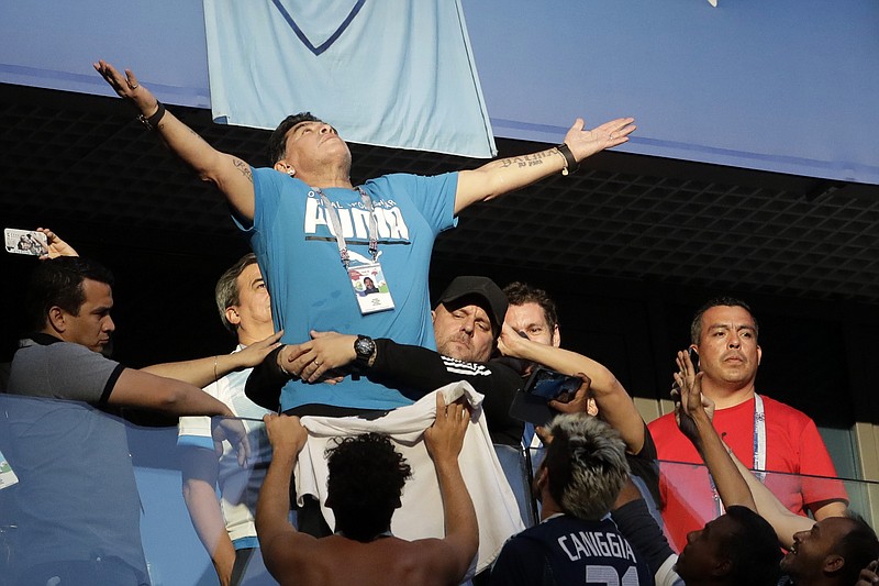 
              Argentina former soccer star Diego Maradona waves to the fans ahead of the group D match between Argentina and Nigeria, at the 2018 soccer World Cup in the St. Petersburg Stadium in St. Petersburg, Russia, Tuesday, June 26, 2018. (AP Photo/Petr David Josek)
            