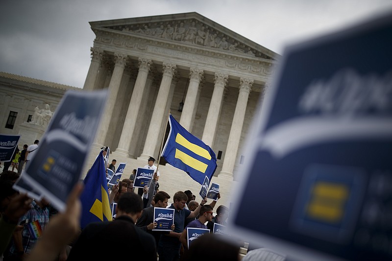 Protesters with Human Rights Campaign flags outside the Supreme Court following the court's ruling in the case of a Colorado baker who refused to create a custom wedding cake for a gay couple. A new justice retirement puts the balance of the court — and the nation — in jeopardy.