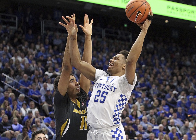 Kentucky's Pj Washington (25) shoots while defended by Missouri's Jontay Porter (11) during the first half of an NCAA college basketball game Saturday, Feb. 24, 2018, in Lexington, Ky.(AP Photo/James Crisp)