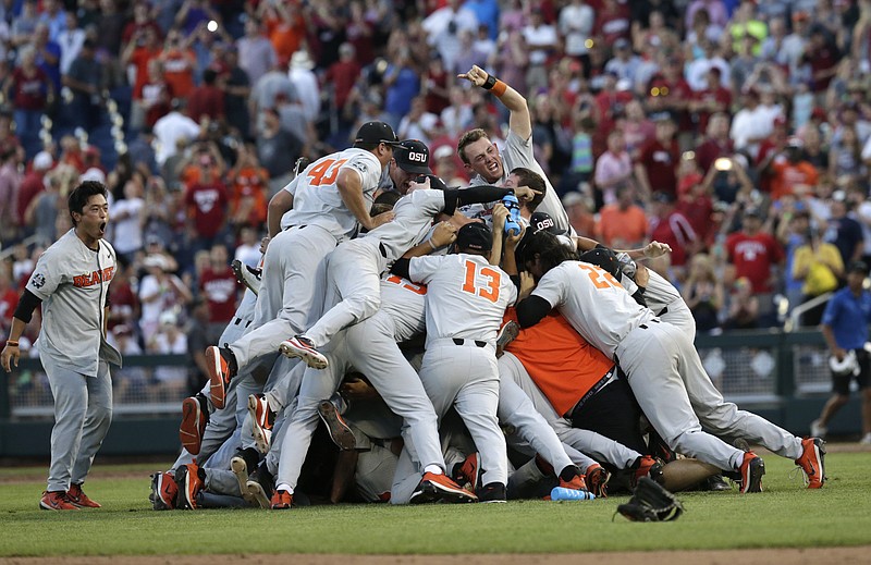Oregon State players celebrate beating Arkansas 5-0 to win the College World Series on Thursday night in Omaha, Neb.