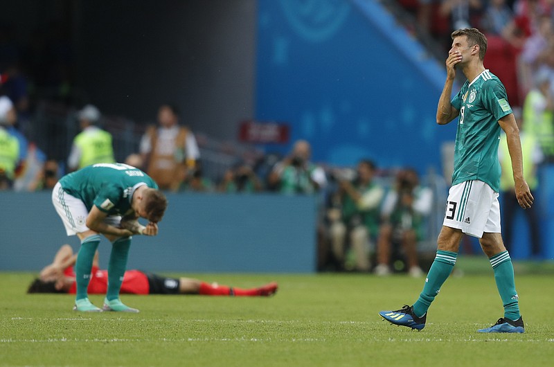 
              Germany's Thomas Mueller, right, wipes his face after his team lose the group F match between South Korea and Germany, at the 2018 soccer World Cup in the Kazan Arena in Kazan, Russia, Wednesday, June 27, 2018. South Korea won the match 2-0. (AP Photo/Frank Augstein)
            
