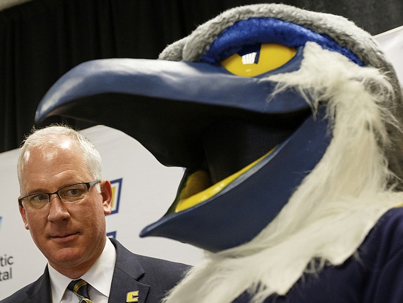 Mark Wharton meets Scrappy, UTC's mascot, after a news conference last August introducing Wharton as the school's new athletic director.