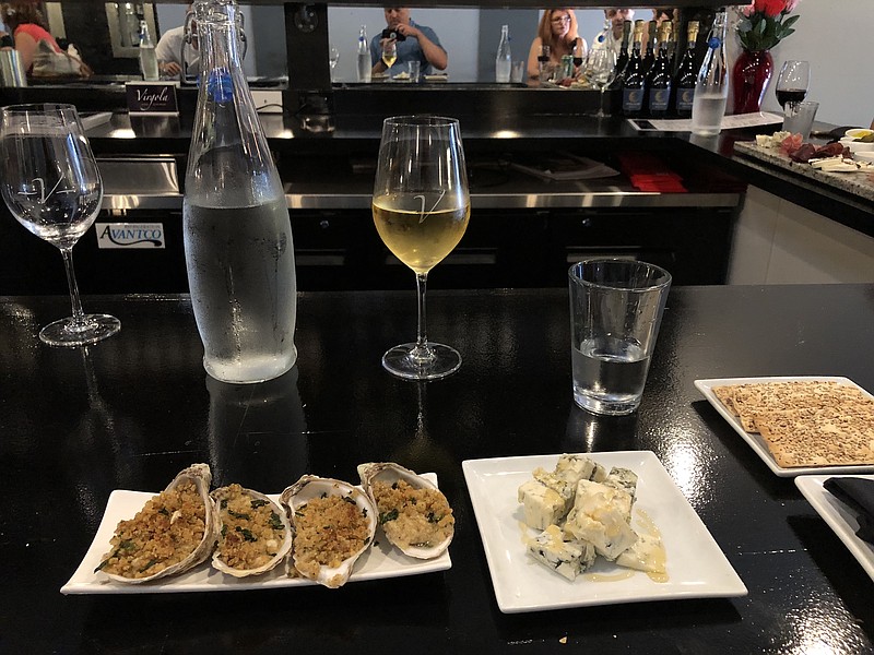 Four stuffed oysters broiled with bread crumbs and spices is beautifully plated, served with Gorgonzola cheese, which is a soft, mild bleu cheese.