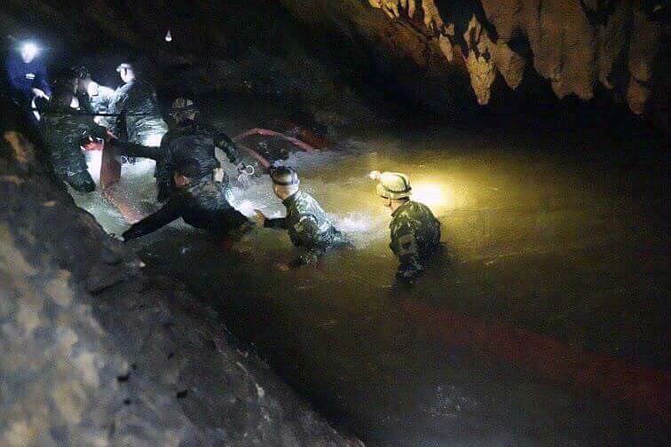 In this handout photo released by Tham Luang Rescue Operation Center, Thai rescue teams walk inside cave complex where 12 boys and their soccer coach went missing, in Mae Sai, Chiang Rai province, in northern Thailand, Monday, July 2, 2018. Rescue divers are advancing in the main passageway inside the flooded cave in northern Thailand where the boys and their coach have been missing more than a week. (Tham Luang Rescue Operation Center via AP)