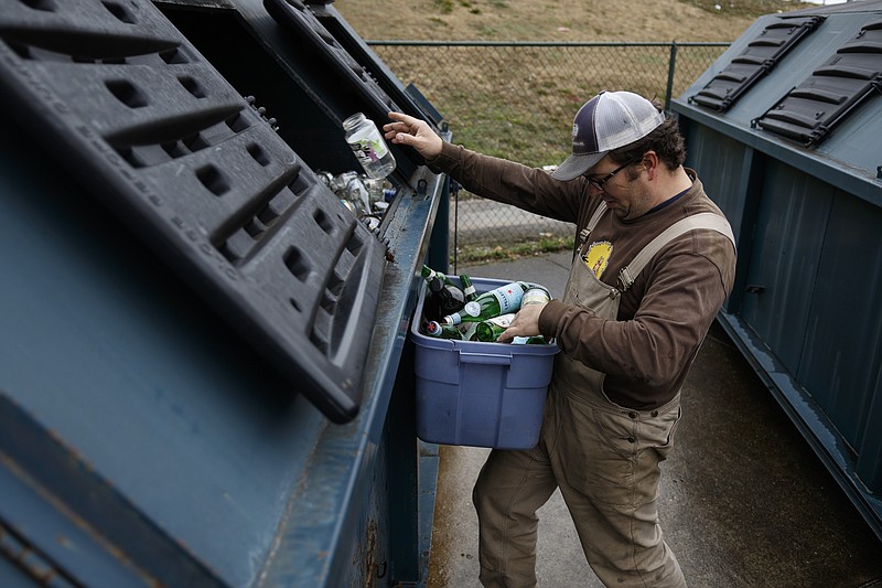 Georg Petmecky recycles glass at the city's Warner Park recycling center in January. Chattanooga officials say they will not bring back collection of glass in the single-stream curbside recycling program.