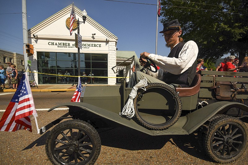 Cody Card drives a small vehicle past the Chamber of Commerce Wednesday in the annual Fourth of July parade in downtown Dunlap.
