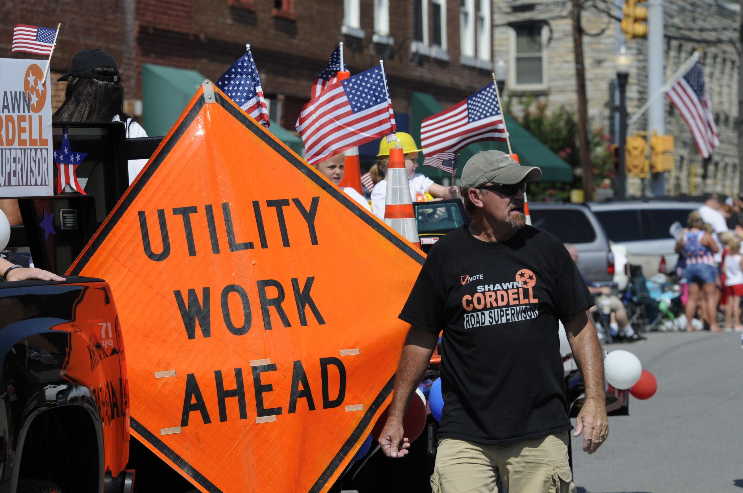 Candidate for Road Supervisor Shawn Cordell walks alongside his float on Cherry Street during the annual Fourth of July parade Wednesday in downtown Dunlap.