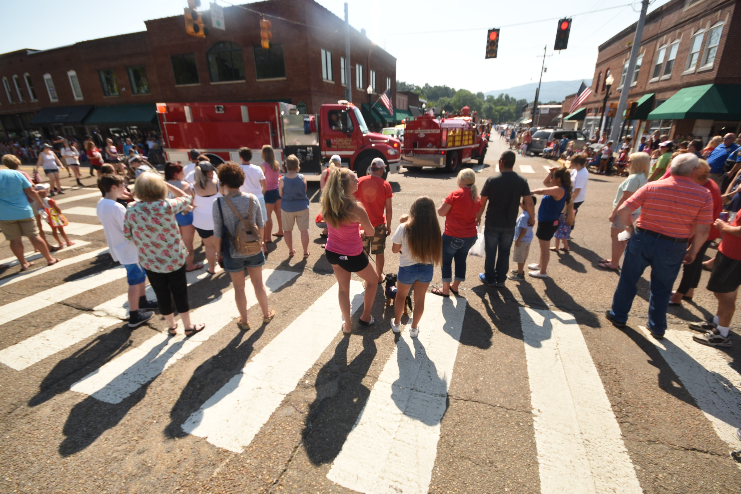 Parade watchers crowd the intersection of Rankin and Cherry to watch the annual Fourth of July parade in Dunlap.
