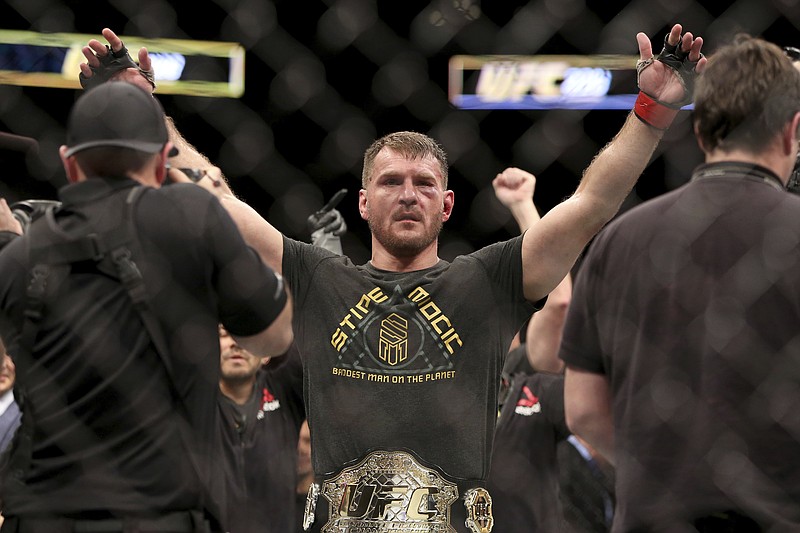 
              FILE - In this Jan. 21, 2018, file photo, Stipe Miocic gestures after a win over Francis Ngannou during a heavyweight championship mixed martial arts bout at UFC 220, in Boston. Miocic will get the biggest paycheck of his career at UFC 226 for the biggest test of his fighting life against light heavyweight champ Daniel Cormier.(AP Photo/Gregory Payan, File)
            