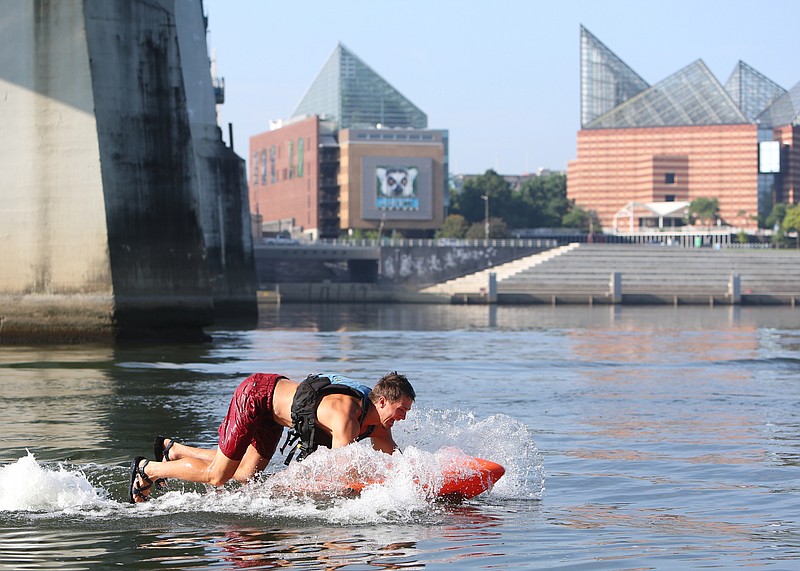 Cole Henderson, an adventure guide with Adventure Sports Innovation, shows off a Kymera electric jet body board in the Tennessee River under the Market Street Bridge Thursday, July 5, 2018 in Chattanooga, Tennessee. The board is one of Adventure Sports Innovation's products that they have for customers to use at their North Shore location. 