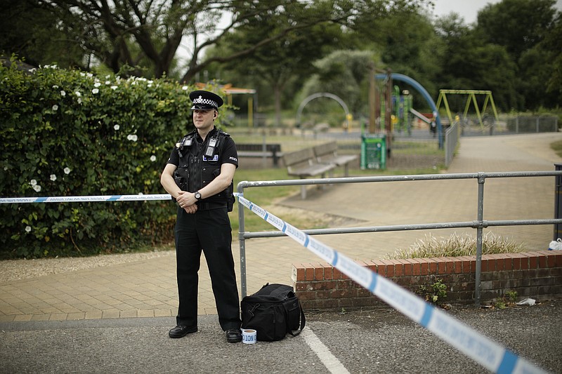 A British police officer guards a cordon outside the Queen Elizabeth Gardens park in Salisbury, England, Wednesday, July 4, 2018. British police have declared a "major incident" after two people were exposed to an unknown substance in a town near where a former Russian spy and his daughter were poisoned with nerve agent. (AP Photo/Matt Dunham)