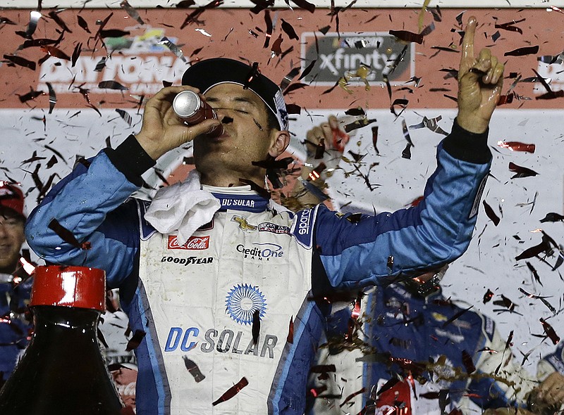 Kyle Larson celebrates after winning the NASCAR Xfinity Series race Friday night at Daytona International Speedway in Daytona Beach, Fla.