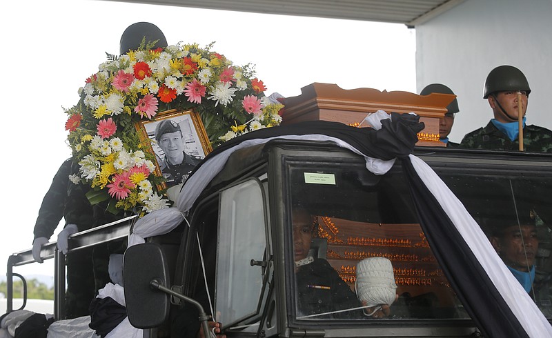 The body of Saman Gunan, a former Thai navy SEAL who died during an overnight mission, is carried during a repatriation and religious rites ceremony at Chiang Rai Airport in Mae Sai, Chiang Rai province, in northern Thailand Friday, July 6, 2018. The Thai navy diver working as part of the effort to rescue 12 boys and their soccer coach trapped in a flooded cave died Friday from lack of oxygen, underscoring risks of extracting the team. (AP Photo)