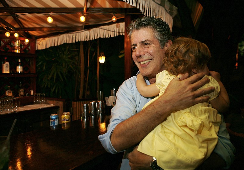 FILE - In this Nov. 12, 2008 file photo, Chef Anthony Bourdain holds his daughter Ariane in Miami Beach. 