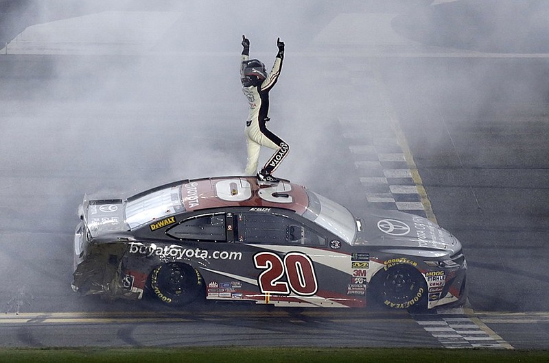 NASCAR driver Erik Jones celebrates on top of his car after winning Saturday night at Daytona International Speedway for the first Cup Series victory of his career.