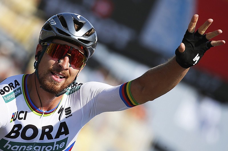 Peter Sagan celebrates as he crosses the finish line to win the second stage of the Tour de France on Sunday. Sagan moved into the overall lead and will wear the coveted yellow jersey Monday as the 21-stage event continues.