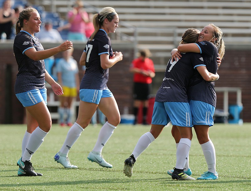 Chattanooga FC's Mia Hollingsworth, second from right, celebrates with Carlie Banks after Banks headed in a cross from Hollingsworth for the first goal of a 2-0 win against the Cincinnati Sirens FC on Sunday at Finley Stadium.