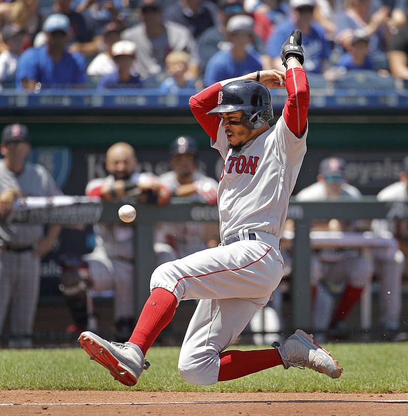 Boston Red Sox's Mookie Betts slides home to score on a sacrifice fly by Steve Pearce during the third inning of a baseball game against the Kansas City Royals, Sunday, July 8, 2018, in Kansas City, Mo. (AP Photo/Charlie Riedel)