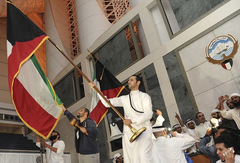 
              In this Nov. 16, 2011, file photo, dozens of Kuwaitis briefly storm Kuwait's parliament building as hundreds of others protested outside in Kuwait City, Kuwait. Kuwait's highest court on Sunday ordered an opposition leader and several lawmakers imprisoned for 3½ years over the 2011 storming of parliament during the country's Arab Spring protests. (AP Photo/Nasser Waggi, File)
            
