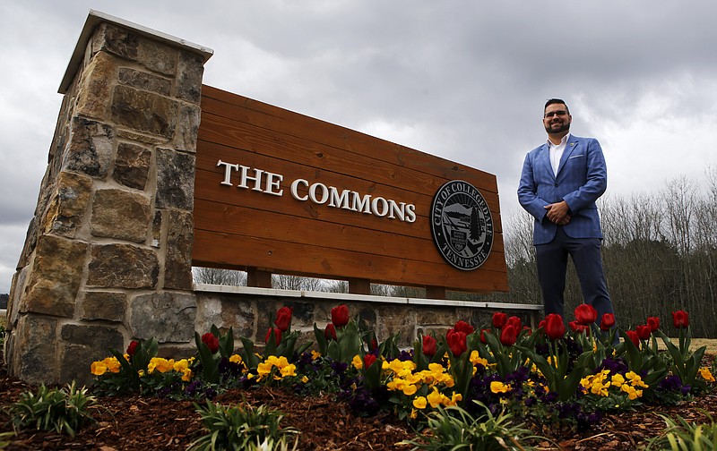 Collegedale Commissioner Ethan White stands next to a sign for The Commons on Friday, March 30, 2018, in Collegedale, Tenn.