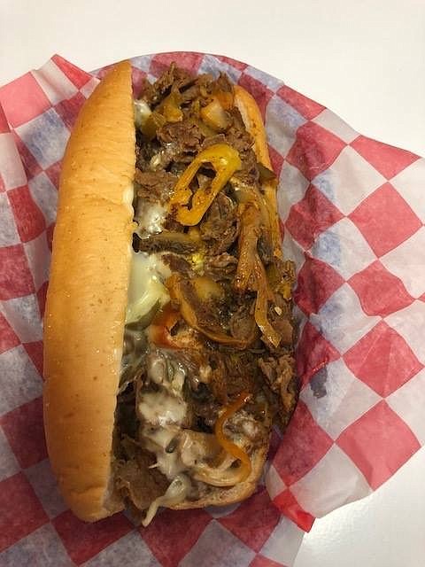 One of Mad Philly's most popular menu items is the Mad Mike Cheesesteak, a spicier version of the original featuring extra meat, extra cheese, mushrooms, fried onions, banana peppers, jalapeno peppers, bacon and hot sauce.