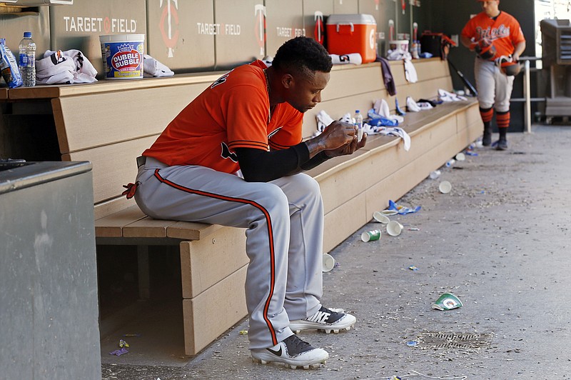 
              Baltimore Orioles' Tim Beckham sits alone on the bench after grounding out to end the baseball game against the Minnesota Twins, Saturday, July 7, 2018, in Minneapolis. The Twins won 5-4. (AP Photo/Jim Mone)
            